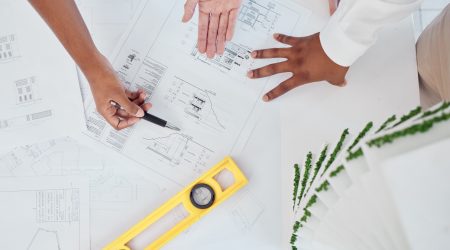 Architect, hands and construction planning for building industry in team discussion or meeting on t